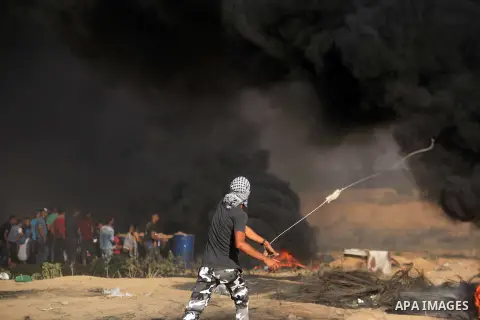 Palestinian protesters gather during clashes with Israeli troops in tents protest where Palestinian demand the right to return to their homeland at the Israel-Gaza border, in al-Bureij in the center of Gaza Strip on July...