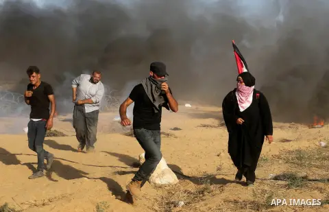 Palestinian protesters gather during clashes with Israeli troops in tents protest where Palestinian demand the right to return to their homeland at the Israel-Gaza border, in Khan Younis in the southern Gaza Strip on Jul...