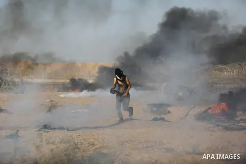 Palestinian protesters gather during clashes with Israeli troops in tents protest where Palestinian demand the right to return to their homeland at the Israel-Gaza border, in Khan Younis in the southern Gaza Strip on Jul...