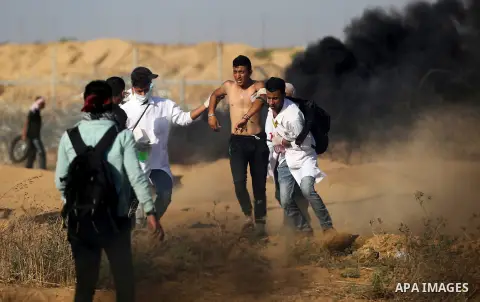 Palestinian protesters gather during clashes with Israeli troops in tents protest where Palestinian demand the right to return to their homeland at the Israel-Gaza border, in Khan Younis in the southern Gaza Strip on Jul...