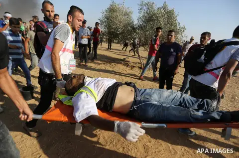 A wounded Palestinian protester is evacuated during clashes with Israeli troops in tents protest where Palestinian demand the right to return to their homeland at the Israel-Gaza border, in Khan Younis in the southern Ga...