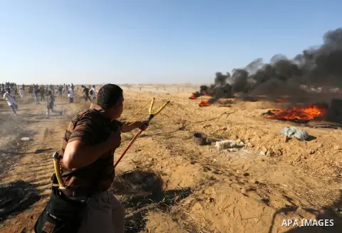 Palestinian protesters gather during clashes with Israeli troops in tents protest where Palestinian demand the right to return to their homeland at the Israel-Gaza border, in Khan Younis in the southern Gaza Strip on Jul...