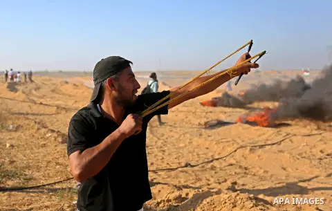 Palestinian protesters gather during clashes with Israeli troops in tents protest where Palestinian demand the right to return to their homeland at the Israel-Gaza border, in Khan Younis in the southern Gaza Strip on Jul...