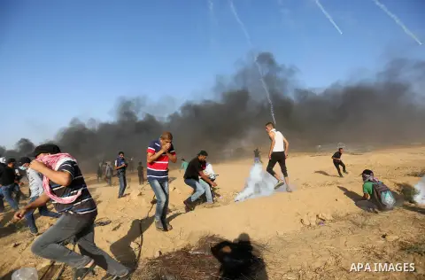 Palestinian protesters gather during clashes with Israeli troops in tents protest where Palestinian demand the right to return to their homeland at the Israel-Gaza border, in Khan Younis in the southern Gaza Strip on Jul...