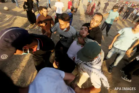 A wounded Palestinian protester is evacuated during clashes with Israeli troops in tents protest where Palestinian demand the right to return to their homeland at the Israel-Gaza border, in east of Gaza City on July 6, 2...
