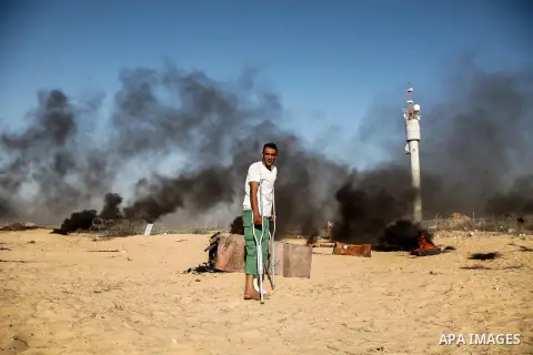 Palestinian protesters gather during clashes with Israeli troops in tents protest where Palestinian demand the right to return to their homeland at the Israel-Gaza border, in Rafah in the southern Gaza Strip on July 6, 2...