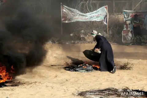 Palestinian protesters gather during clashes with Israeli troops in tents protest where Palestinian demand the right to return to their homeland at the Israel-Gaza border, in Rafah in the southern Gaza Strip on July 6, 2...