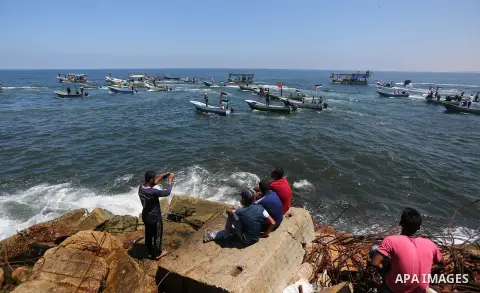 Palestinian activists ride fishing boats sails towards Europe aiming to break Israel's blockade on Gaza, at the sea in Gaza, on July 10, 2018. The Gaza Strip has been under Israeli blockade since 2007. Photo by Ashraf Am...