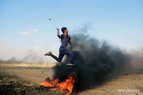 Palestinian protesters gather during clashes with Israeli troops in tents protest where Palestinian demand the right to return to their homeland at the Israel-Gaza border, in al-Bureij in the center of Gaza Strip on July...
