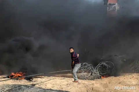 Palestinian protesters gather during clashes with Israeli troops in tents protest where Palestinian demand the right to return to their homeland at the Israel-Gaza border, in Rafah in the southern Gaza Strip on July 13,...