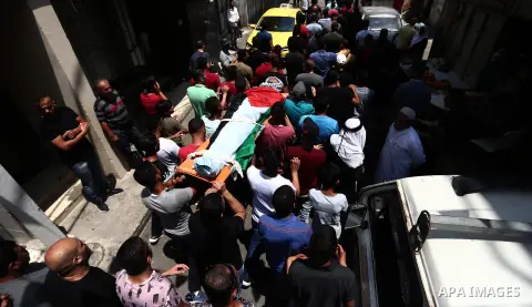 Mourners carry the body of Palestinian assailant Mohammad Marshoud ,30, after Israel released his body, during his funeral at Balata refugee camp near in the West Bank city of Nablus, on July 14, 2018. Photo by Shadi Jar...