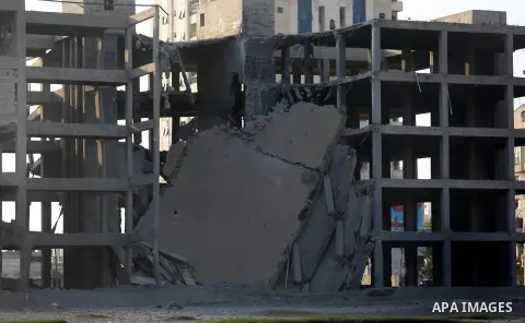 A picture taken on July 14, 2018 shows the damage in a building after an Israeli air strik on the Gaza City. At least two Palestinians were killed after an Israeli air strike hit an empty building in Gaza City. Photo by...