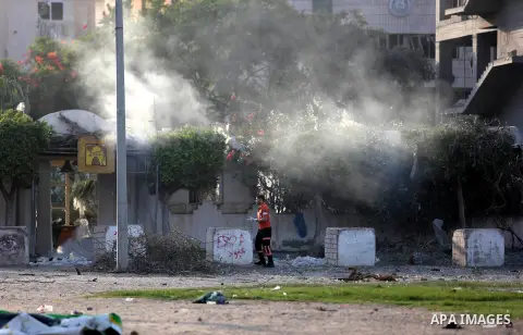 Members of the Palestinian civil defence inspect damage after an Israeli air strik on the Gaza City, on July 14, 2018. At least two Palestinians were killed after an Israeli air strike hit an empty building in Gaza City....