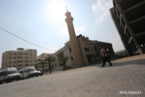 A Palestinian man walks near a mosque that was damaged in an Israeli airstrike on the Gaza City, on July 15, 2018. At least two Palestinians were killed after an Israeli air strike hit an empty building in Gaza City. Pho...