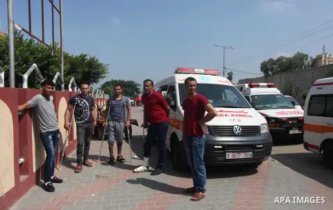 Palestinian ambulance drivers take part in a protest against the siege on the Gaza Strip, outside Indonesian hospital, in the northern of Gaza Strip on July 17, 2018. Photo by Mahmoud Ajour