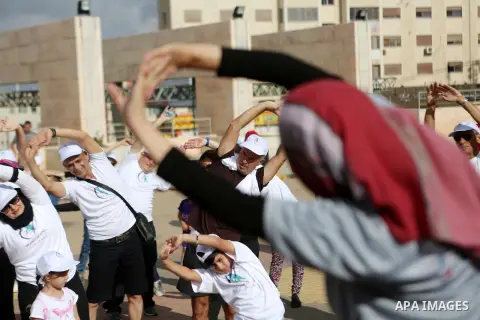 Palestinians take part in the challenge of walking, under the title: "Challenge your age" in the West Bank city of Ramallah, on July 20, 2018. Photo by Shadi Hatem
