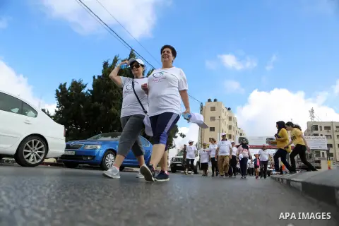 Palestinians take part in the challenge of walking, under the title: "Challenge your age" in the West Bank city of Ramallah, on July 20, 2018. Photo by Shadi Hatem
