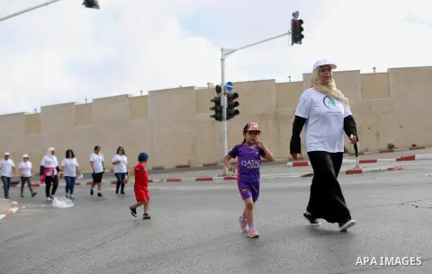 Palestinians take part in the challenge of walking, under the title: "Challenge your age" in the West Bank city of Ramallah, on July 20, 2018. Photo by Shadi Hatem