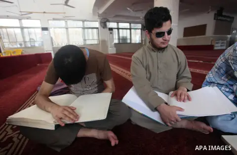 Palestinian blind boys read and memorise the holy Quran in braille at Dar al-Quran and Sunnah in Gaza city, on July 23, 2018. Photo by Mahmoud Ajour