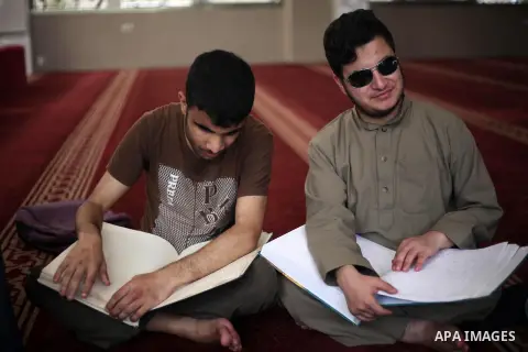 Palestinian blind boys read and memorise the holy Quran in braille at Dar al-Quran and Sunnah in Gaza city, on July 23, 2018. Photo by Mahmoud Ajour