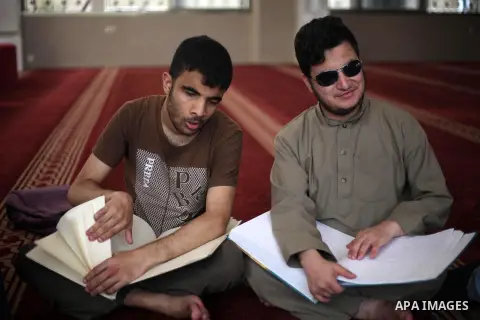 Palestinian blind boys read and memorise the holy Quran in braille at Dar al-Quran and Sunnah in Gaza city, on July 23, 2018. Photo by Mahmoud Ajour
