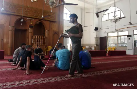 Palestinian blind boys read and memorise the holy Quran in braille at Dar al-Quran and Sunnah in Gaza city, on July 23, 2018. Photo by Mahmoud Ajour