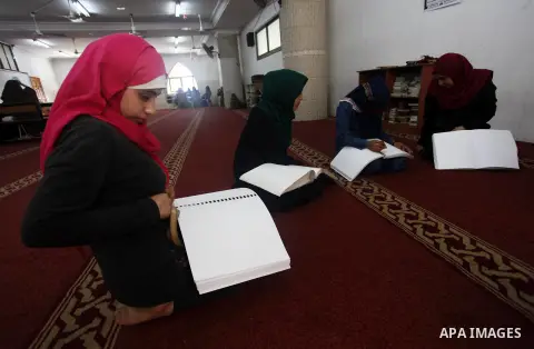 Palestinian blind girls read and memorise the holy Quran in braille at Dar al-Quran and Sunnah in Gaza city, on July 23, 2018. Photo by Mahmoud Ajour