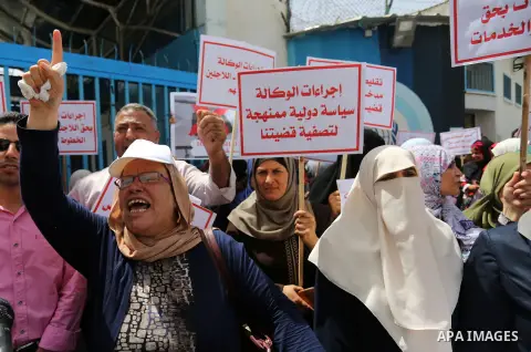 Palestinian employees of United Nations Relief and Works Agency (UNRWA) take part in a protest against jobs termination by UNRWA outside its headquarters in Gaza City, on July 25, 2018. Photo by Ashraf Amra