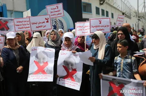 Palestinian employees of United Nations Relief and Works Agency (UNRWA) take part in a protest against jobs termination by UNRWA outside its headquarters in Gaza City, on July 25, 2018. Photo by Ashraf Amra