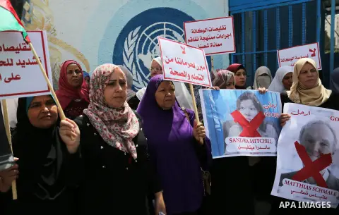 Palestinian employees of United Nations Relief and Works Agency (UNRWA) take part in a protest against jobs termination by UNRWA outside its headquarters in Gaza City, on July 25, 2018. Photo by Ashraf Amra
