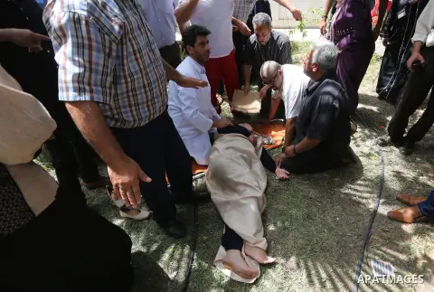 An employee of United Nations Relief and Works Agency (UNRWA) faints during a protest against jobs termination by UNRWA inside its headquarters in Gaza City, on July 25, 2018. Photo by Ashraf Amra