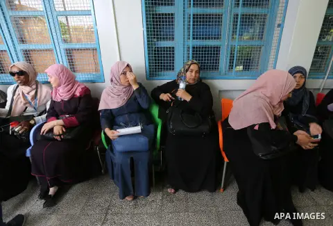 Palestinian employees of United Nations Relief and Works Agency (UNRWA) take part in a protest against jobs termination by UNRWA outside its headquarters in Gaza City, on July 25, 2018. Photo by Ashraf Amra