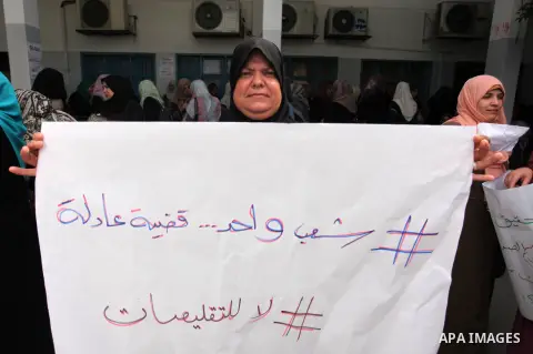 Palestinian employees of United Nations Relief and Works Agency (UNRWA) take part in a protest against jobs termination by UNRWA inside its headquarters in Gaza City, on July 26, 2018. Photo by Mahmoud Ajour