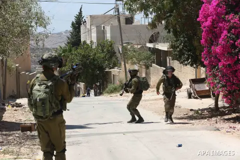 Israeli security forces take position during clashes with Palestinian protesters following a demonstration against the expropriation of Palestinian land by Israel in the village of Kfar Qaddum, near Nablus, in the occupi...