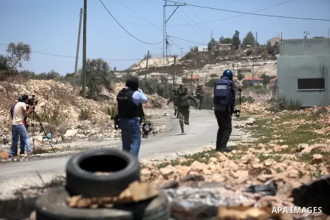Palestinian protesters gather during clashes with Israeli troops following a demonstration against the expropriation of Palestinian land by Israel in the village of Kfar Qaddum, near Nablus, in the occupied West Bank on...