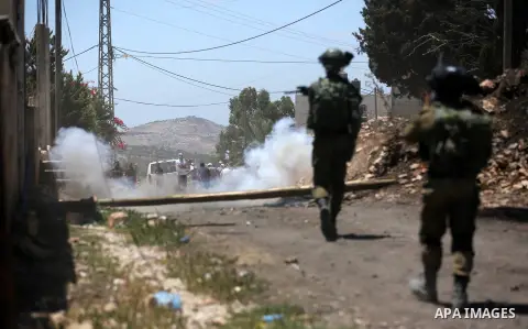Israeli security forces take position during clashes with Palestinian protesters following a demonstration against the expropriation of Palestinian land by Israel in the village of Kfar Qaddum, near Nablus, in the occupi...