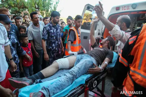 A Palestinian who was wounded during clashes with Israeli troops at Gaza-Israel border is carried on stretcher outside a hospital, in Jabalia in the northern of Gaza Strip on July 27, 2018. Photo by Ramez Habboub
