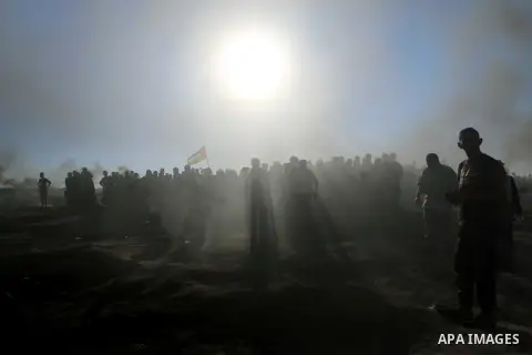 Palestinian protesters gather during clashes with Israeli troops in tents protest where Palestinian demand the right to return to their homeland at the Israel-Gaza border, in al-Bureij in the center of Gaza Strip on July...