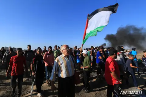 Palestinian protesters gather during clashes with Israeli troops in tents protest where Palestinian demand the right to return to their homeland at the Israel-Gaza border, in al-Bureij in the center of Gaza Strip on July...