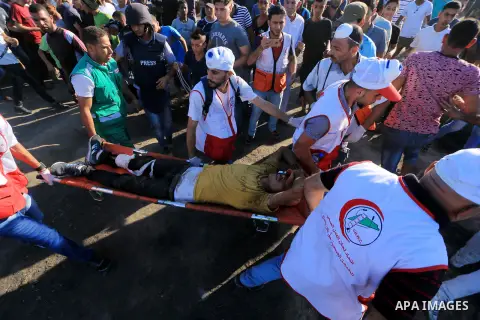Palestinian protesters gather during clashes with Israeli troops in tents protest where Palestinian demand the right to return to their homeland at the Israel-Gaza border, in al-Bureij in the center of Gaza Strip on July...
