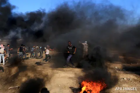 Palestinian protesters gather during clashes with Israeli troops in tents protest where Palestinian demand the right to return to their homeland at the Israel-Gaza border, in al-Bureij in the center of Gaza Strip on July...