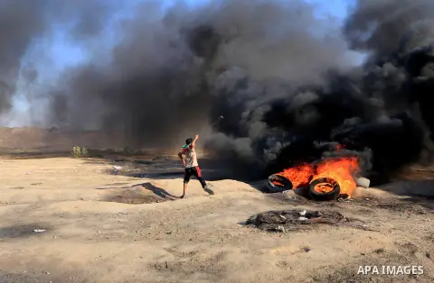 Palestinian protesters gather during clashes with Israeli troops in tents protest where Palestinian demand the right to return to their homeland at the Israel-Gaza border, in al-Bureij in the center of Gaza Strip on July...