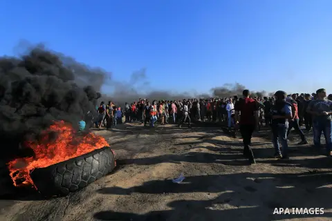 Palestinian protesters gather during clashes with Israeli troops in tents protest where Palestinian demand the right to return to their homeland at the Israel-Gaza border, in al-Bureij in the center of Gaza Strip on July...
