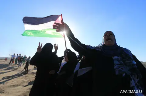Palestinian protesters gather during clashes with Israeli troops in tents protest where Palestinian demand the right to return to their homeland at the Israel-Gaza border, in al-Bureij in the center of Gaza Strip on July...