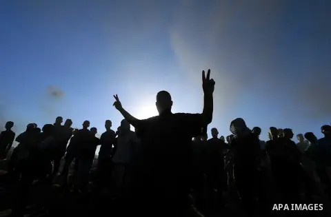 Palestinian protesters gather during clashes with Israeli troops in tents protest where Palestinian demand the right to return to their homeland at the Israel-Gaza border, in al-Bureij in the center of Gaza Strip on July...
