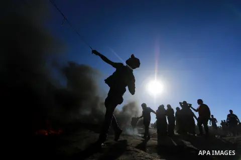 Palestinian protesters gather during clashes with Israeli troops in tents protest where Palestinian demand the right to return to their homeland at the Israel-Gaza border, in al-Bureij in the center of Gaza Strip on July...