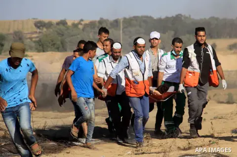 Palestinian protesters gather during clashes with Israeli troops in tents protest where Palestinian demand the right to return to their homeland at the Israel-Gaza border, in al-Bureij in the center of Gaza Strip on July...