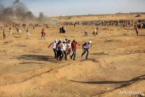 Palestinian protesters gather during clashes with Israeli troops in tents protest where Palestinian demand the right to return to their homeland at the Israel-Gaza border, in east of Gaza City on July 27, 2018. Photo by...