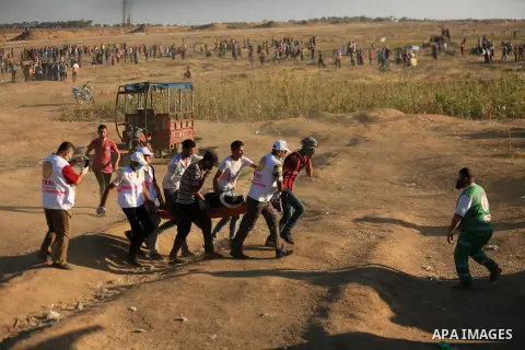 Palestinian protesters gather during clashes with Israeli troops in tents protest where Palestinian demand the right to return to their homeland at the Israel-Gaza border, in east of Gaza City on July 27, 2018. Photo by...