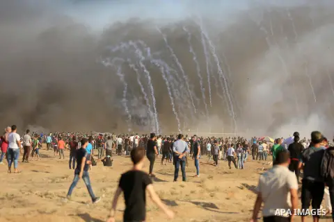 Palestinian protesters gather during clashes with Israeli troops in tents protest where Palestinian demand the right to return to their homeland at the Israel-Gaza border, in east of Gaza City on July 27, 2018. Photo by...